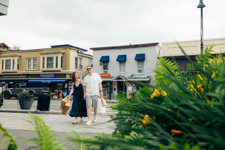 Two people walking on Main Street in Lake Placid