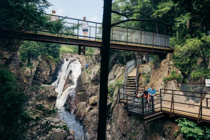 A cascading waterfall surrounded by boardwalks