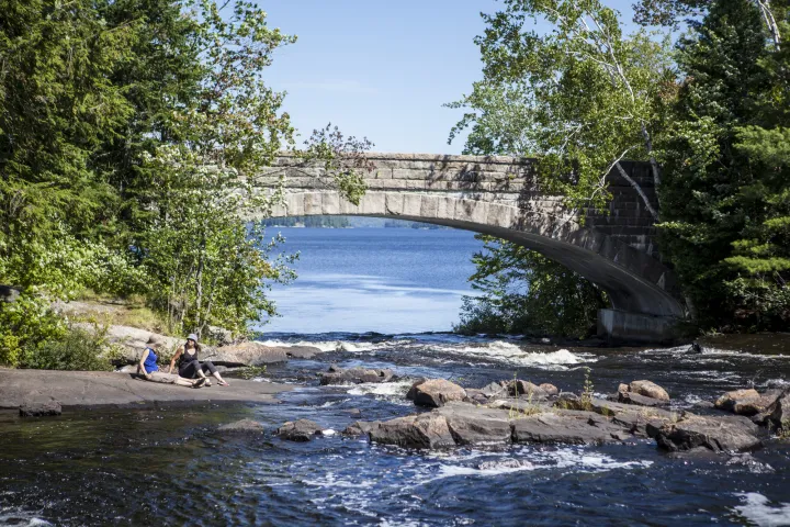 A stone bridge over a short waterfall