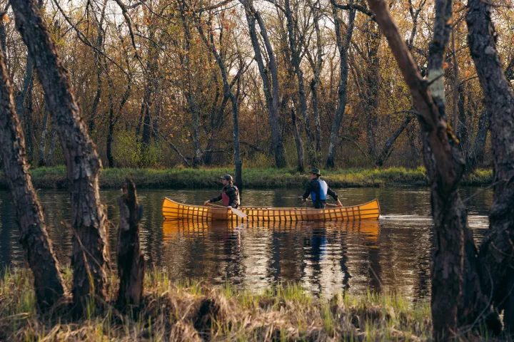 Two people in a pack canoe on the water