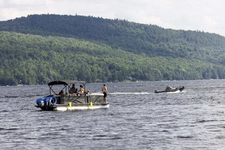 A pontoon boat on a lake