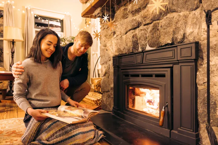A couple sitting by the fire