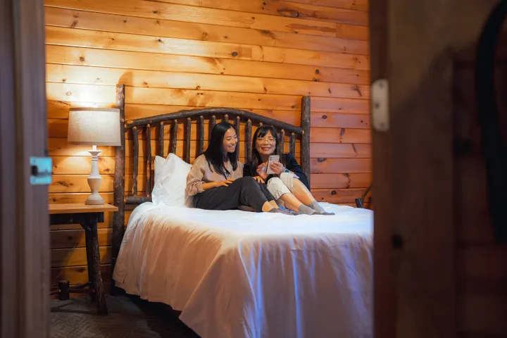 Two woman on a cozy bed