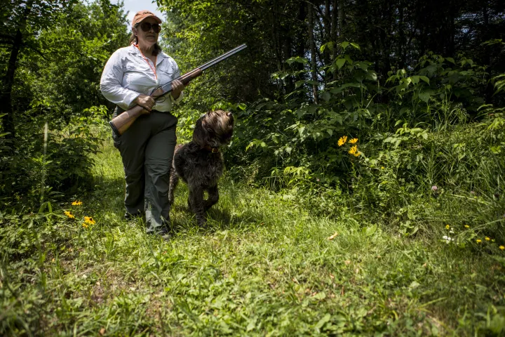 A woman hunting with her dog