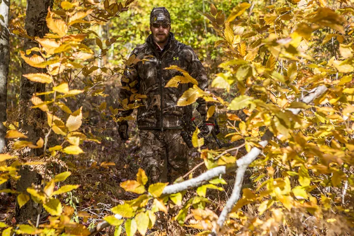 A hunter walking through the woods