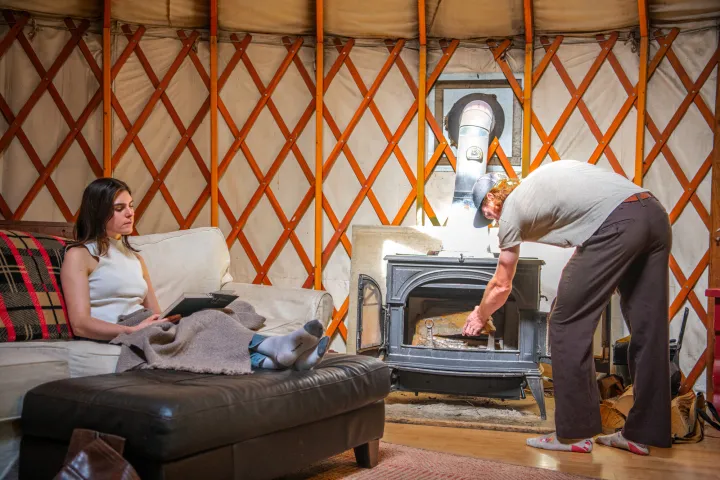A couple in a cozy yurt for a fall farmstay