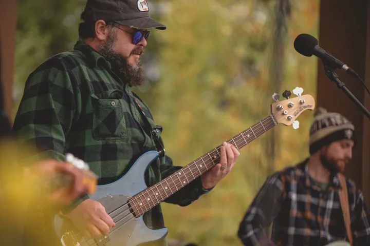 A guy playing the guitar in the fall