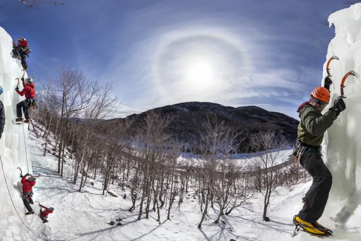 A bunch of ice climbers on the wall