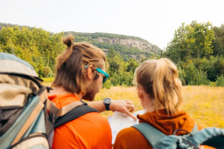 Two climbers planning an ascent with a map