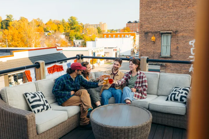 A group of friends having a drink on an outdoor patio in the fall