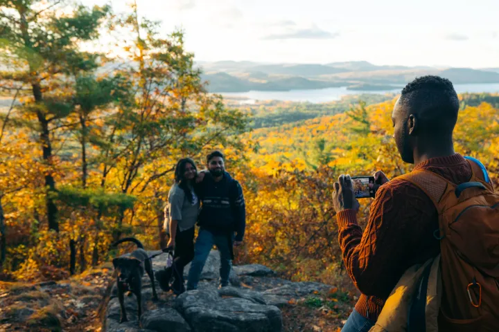 Three hikers on a fall summit