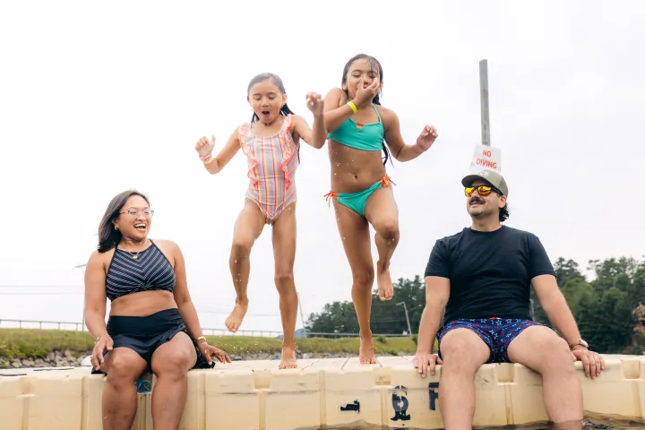 A family on a dock about to swim