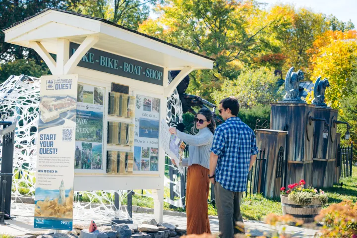 Two people at an information kiosk