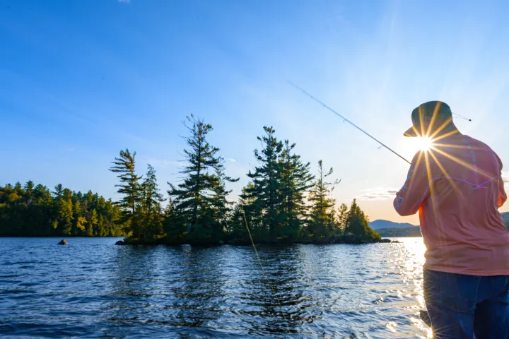 A fisherman at dusk on a boat