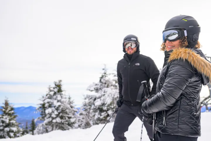 A couple stopped while skiing