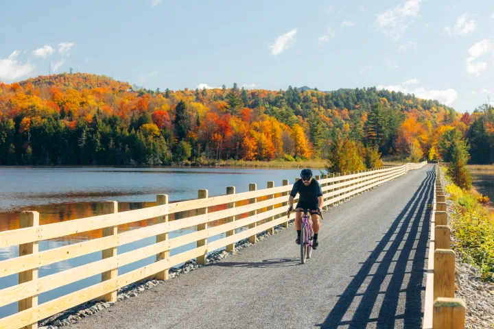 A cyclist on a rail trail in the fall