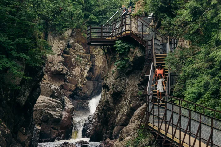 A mom and daughter on a staircase in a gorge
