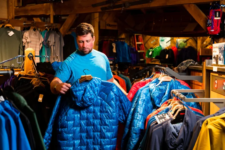 A customer picking out a winter puffy