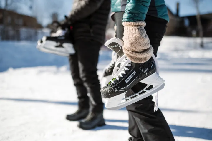 People holding ice skates
