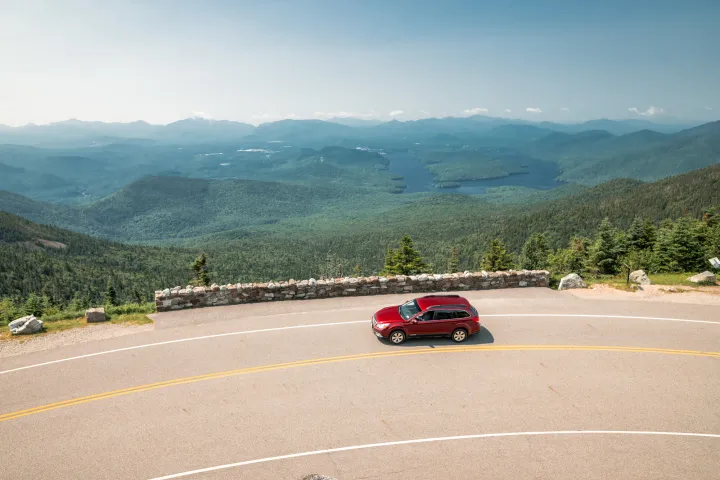 A red car on a mountain road