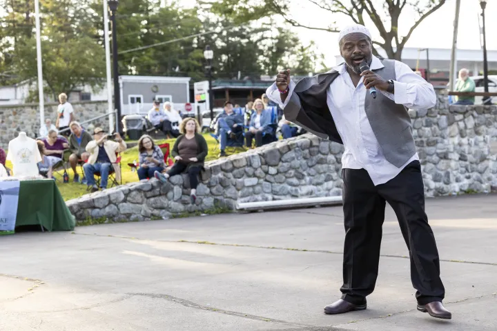 A guy singing in front of a crowd