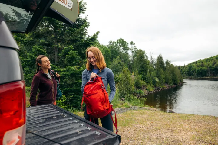 Two women packing for a hike