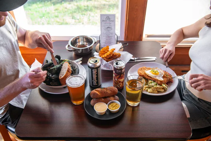 A couple eats dinner together at a restaurant. 
