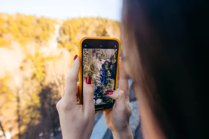 Taking a photo of a waterfall.