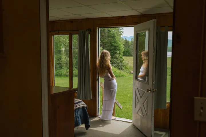 A woman standing in a cabin.