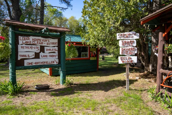 The rustic, twig signs at an Adirondack lodge, advertising cabins, dessert, and more