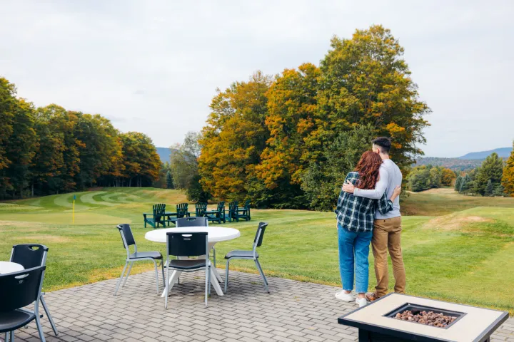 A couple at a golf course in the fall.
