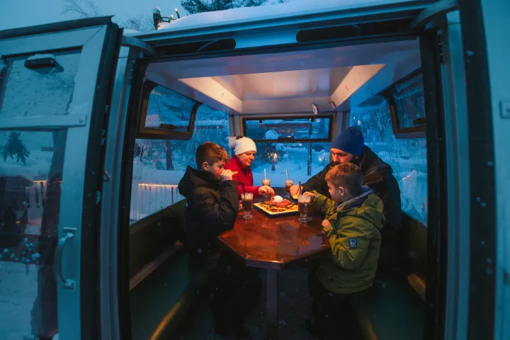 A family dining in a gondola.