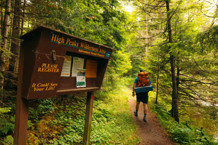 A backpacker leaving the trailhead register