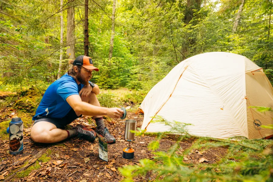 A backcountry camper by his tent