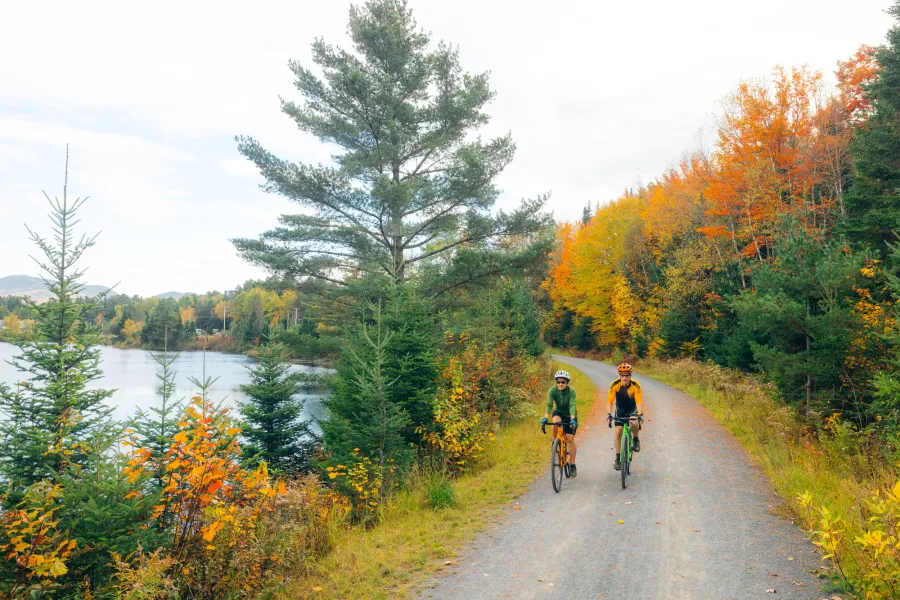 Two cyclists on the Rail Trail in the fall