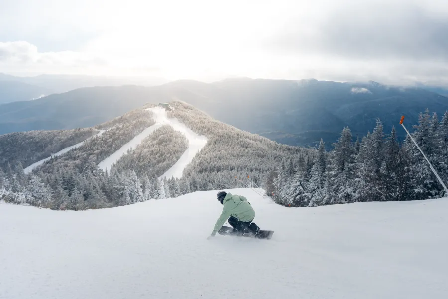 A snowboarder heading towards Little Whiteface