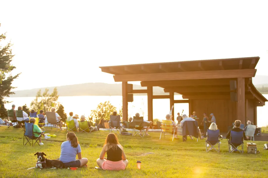 A summer concert at a lakeside bandshell