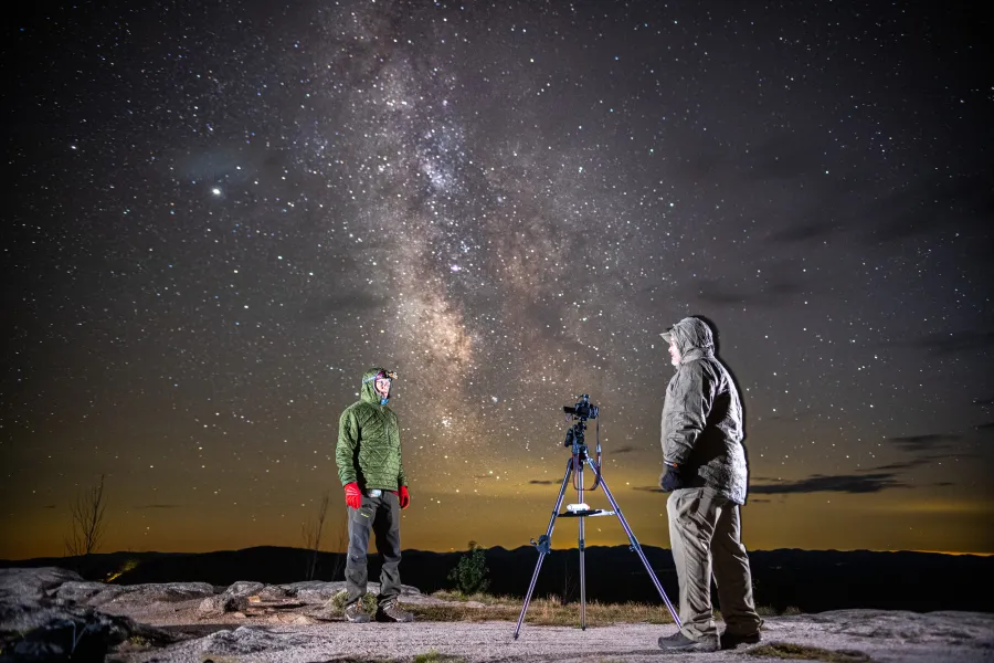 Astrophotographers on Coney Mountain at night under the Milky Way 