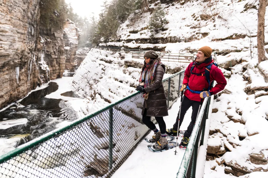 Two people snowshoeing at Ausable Chasm