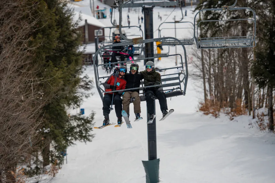 Three people on a ski lift