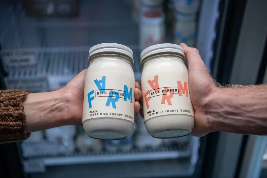 Two people holding fresh milk