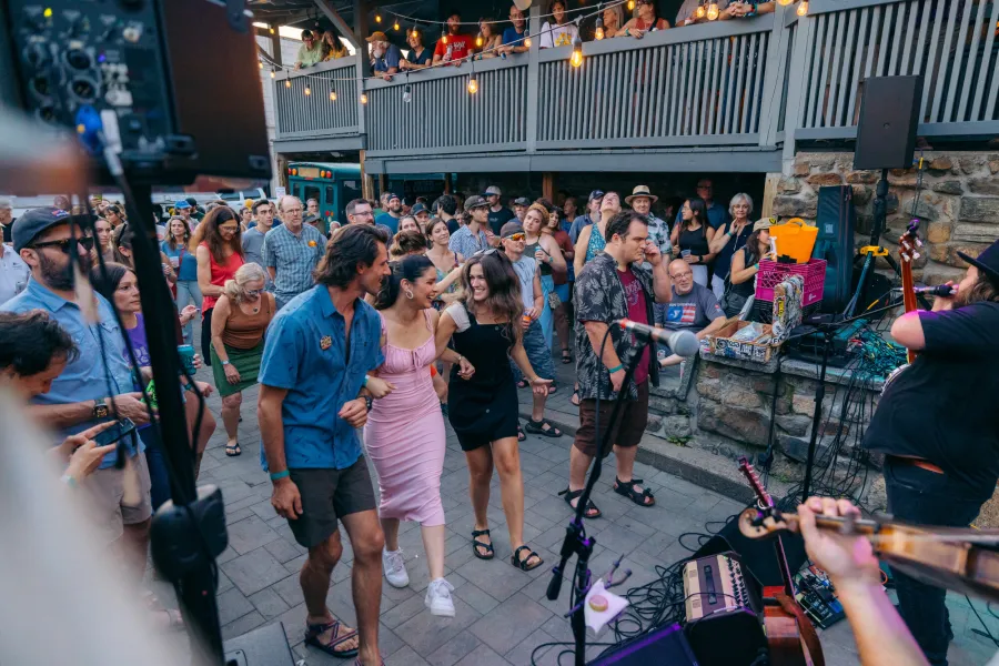 People dancing outside on a patio