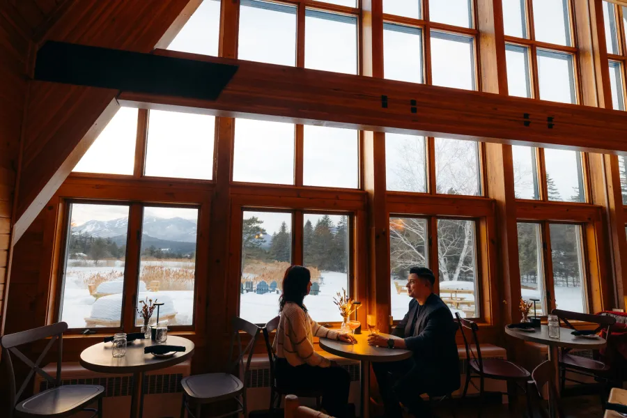 Two people eating in a fancy a-frame restaurant