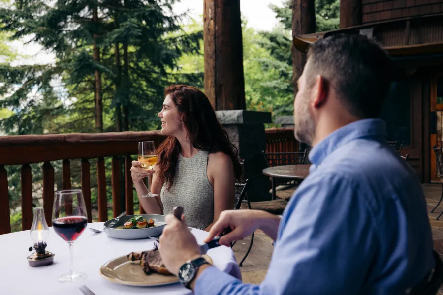 A couple fine dining on a deck
