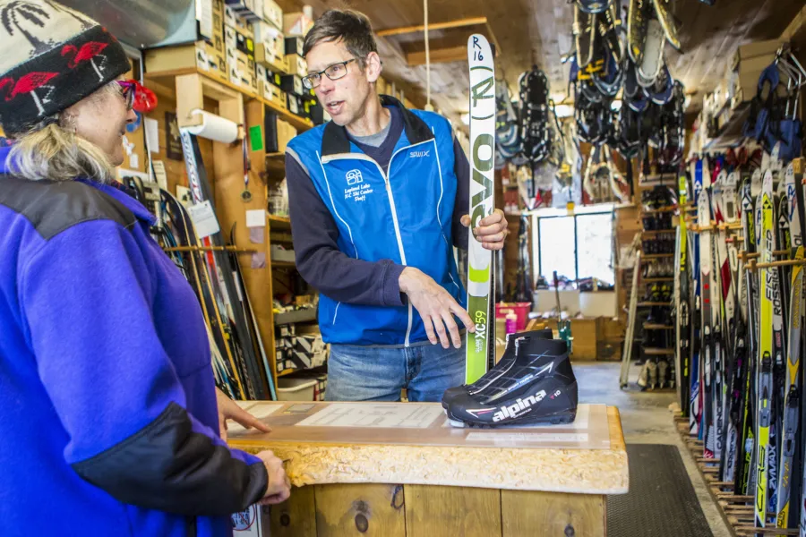 Someone showing a customer xc skis