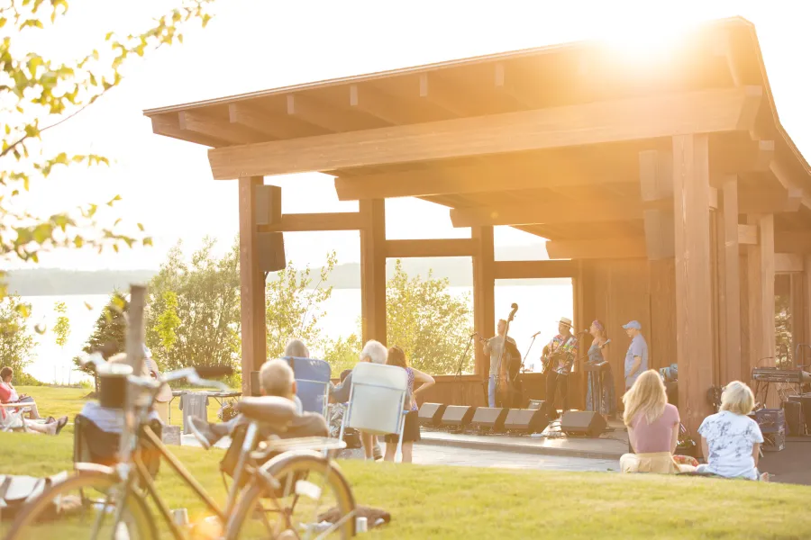 A bandshell by the water during sunset