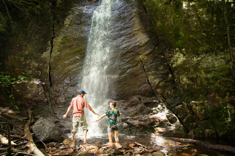 Two people at a plunging waterfall