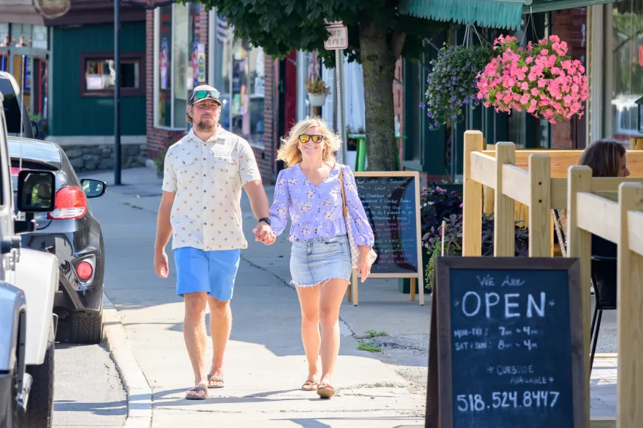 A couple walking down Main Street in Schroon Lake.
