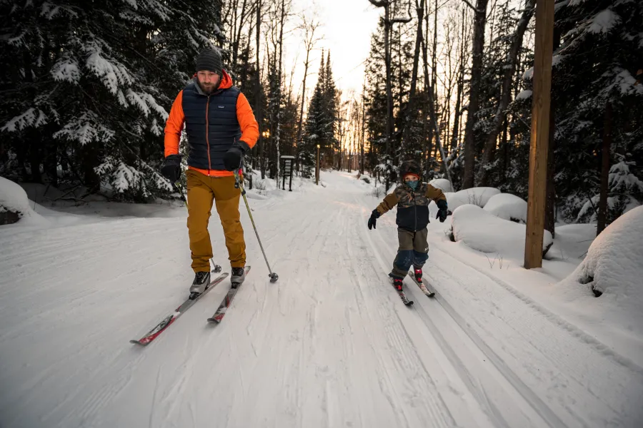 A father and son cross-country skiing