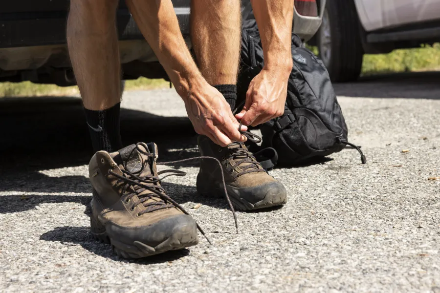 A hiker lacing up their boots.